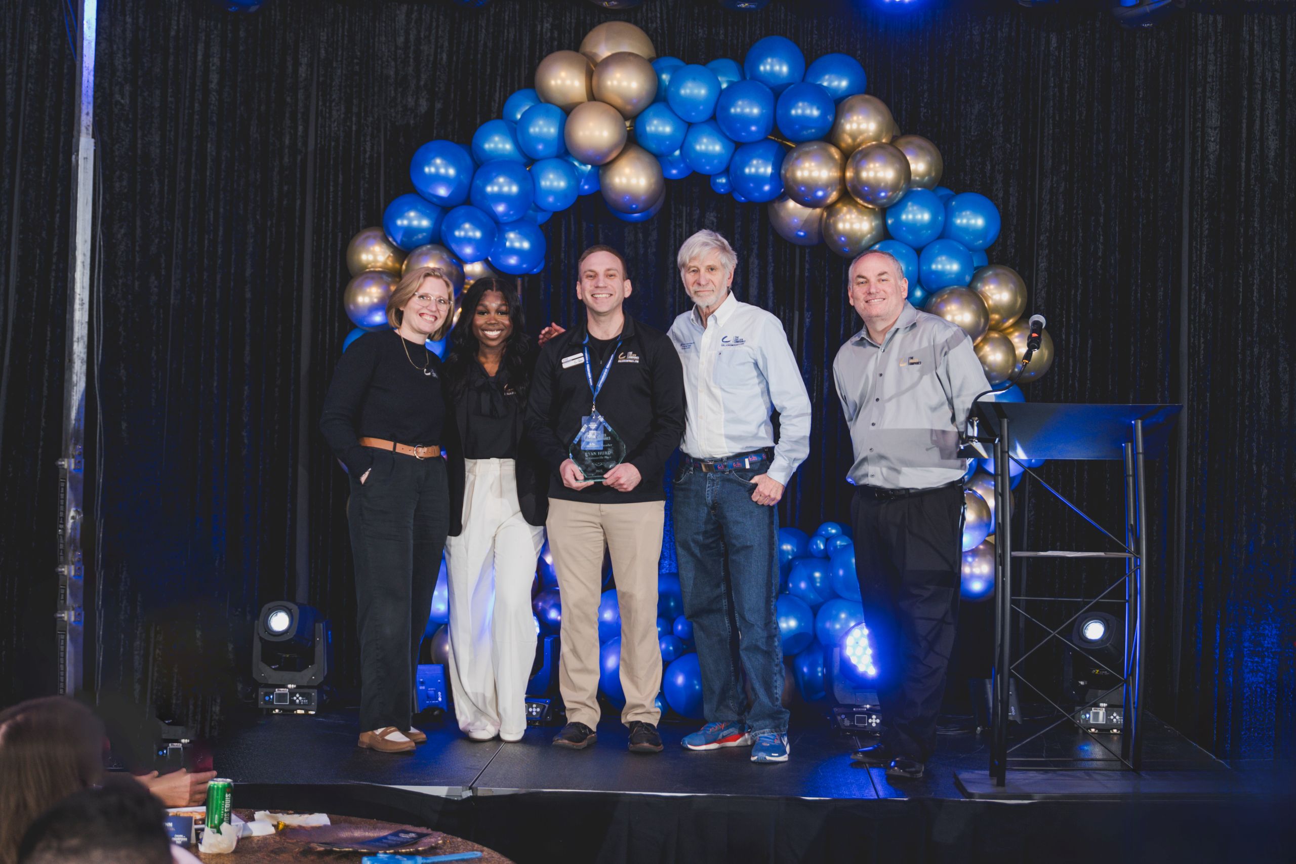 Team members celebrating with an award